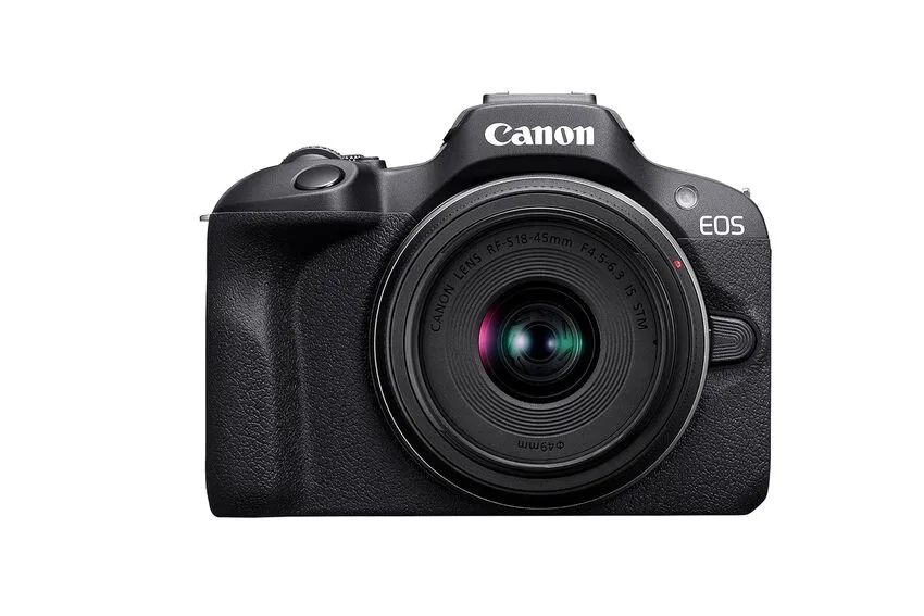 A black Canon EOS R100 mirrorless camera with lens.