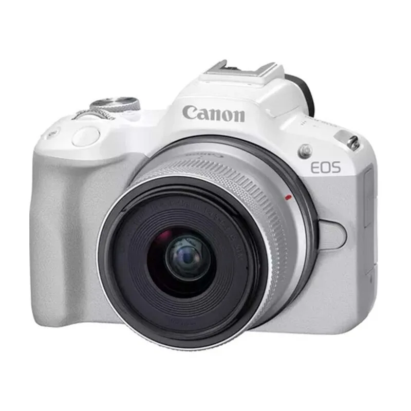 A white Canon EOS R50 mirrorless camera with 18-55mm lens.